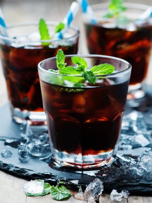 Cuba libre with ice and mint, selective focus